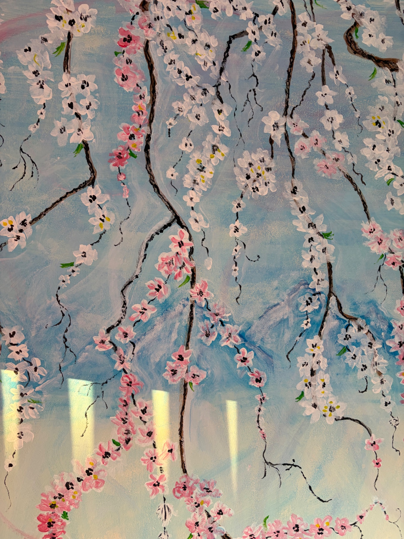 Close detail of cascading pink and white blossoms in the mural